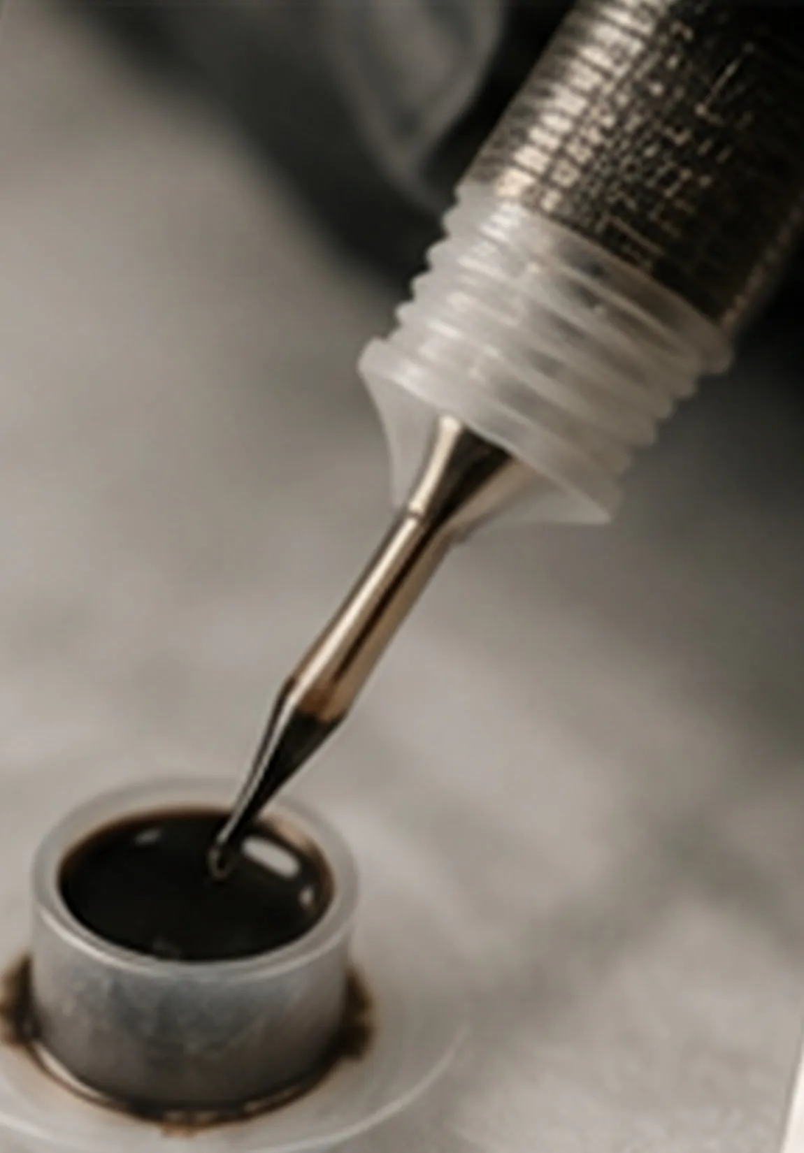 Stylet de micropigmentation trempé dans un godet de pigment
